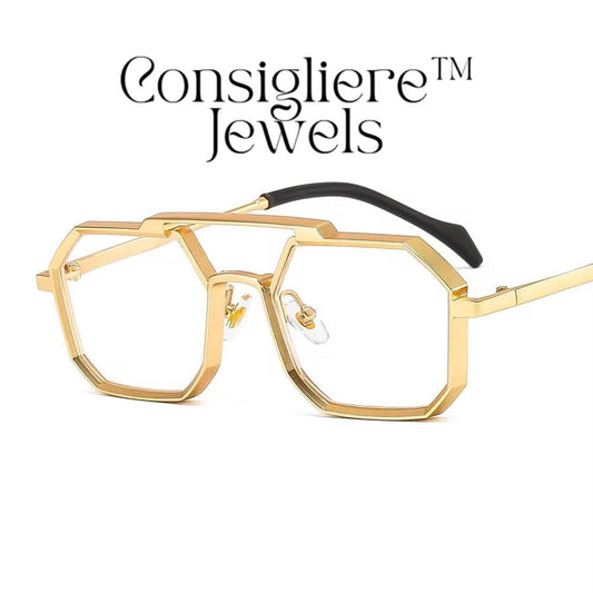 The Consigliere™ Jewels Luxury Sunglasses are high-quality unisex sunglasses with a stylish gold metal frame and polycarbonate lenses. These polygonal sunglasses feature laser engraved branding of the "Consigliere™" name, adding a personalized touch to the design. With a retro 80s and 90s theme, these sunglasses are sure to make a statement and provide both style and protection for any fashion-forward individual.